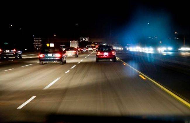 Late night drive through city with reflections of headlights